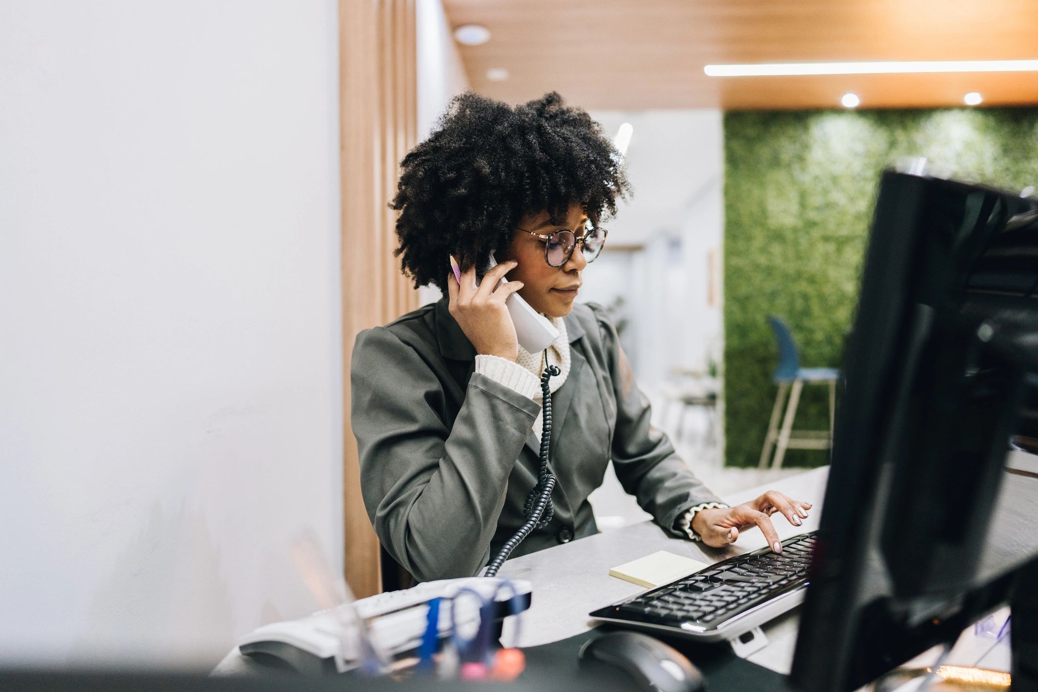 Professional on the phone organizing tasks and notes