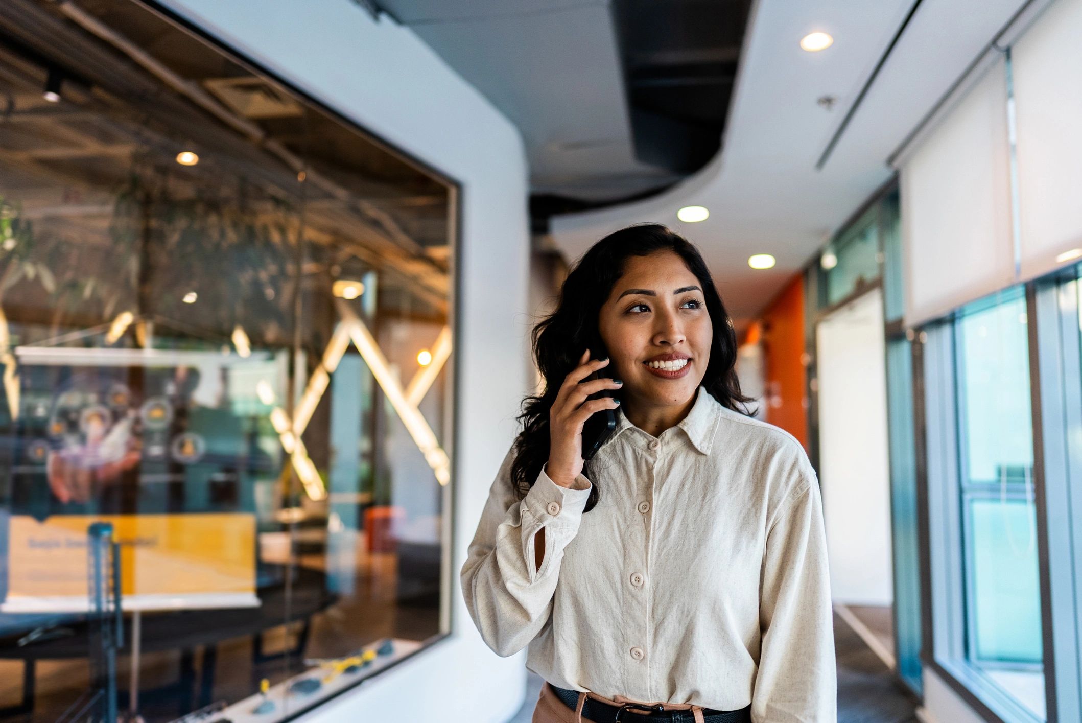 Sales professional on a phone call in a modern office